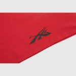 Close-up view of the vintage washed red cotton fabric featuring the signature graphic screen print of a Hellstar T-shirt.