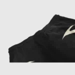 Close-up view of the waistband and graphic design detail on black Hellstar Warm Up shorts, showcasing premium fabric.