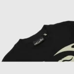 Close-up of the Hellstar Warm Up T-Shirt in black showing the interior neck label and high quality graphic print detail.