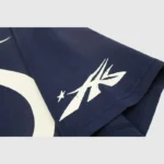 Close up of the premium cotton blue fabric and screen printed graphic detail on a Hellstar Warm Up unisex T-shirt.