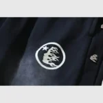 Close-up of the Hellstar Waxed Sweatpant in black featuring a unique circular graphic logo and premium fabric texture.