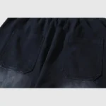 Close-up view of the back pockets and waxed black fabric construction of Hellstar premium streetwear sweatpants.