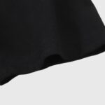 Close-up view of the premium black washed cotton fabric texture of the Hellstar Wrestlemania John Cena T-shirt.