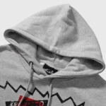 Close-up view of the grey Hellstar x ComplexCon exclusive hoodie showcasing the hood detail and internal brand label.