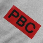 Close-up view of the PBC graphic screen print detail on the Hellstar x ComplexCon Exclusive grey fleece hoodie.