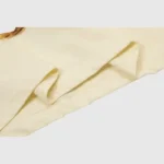 Close-up view of the premium cream-colored fabric and stitching on the Hellstar x Post Malone Austin vintage T-shirt.