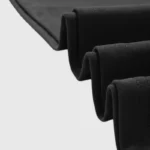 Close-up view of the premium custom-milled 100% cotton fabric used in the black Hellstar x WWE Wrestlemania T-Shirt.