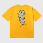 Back view of a bright yellow Hellstar T-shirt featuring a prominent black and grey crack print graphic design.