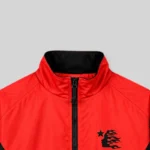Close up view of the Hellstar Thriller red jacket featuring a high collar and signature graphic logo detail.