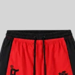 Closeup view of the waist and drawstring area of the Hellstar Thriller red and black colorblock graphic sweatpants