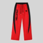 Front view of Hellstar Thriller sweatpants in red with black side panels and logo branding