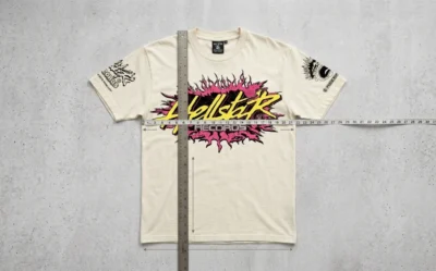 Hellstar graphic t-shirt being measured with a ruler and measuring tape to verify the garment size and fit accuracy.